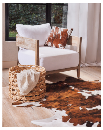 Cowhide rug beautifully accentuating home decor, adding warmth and style to the space