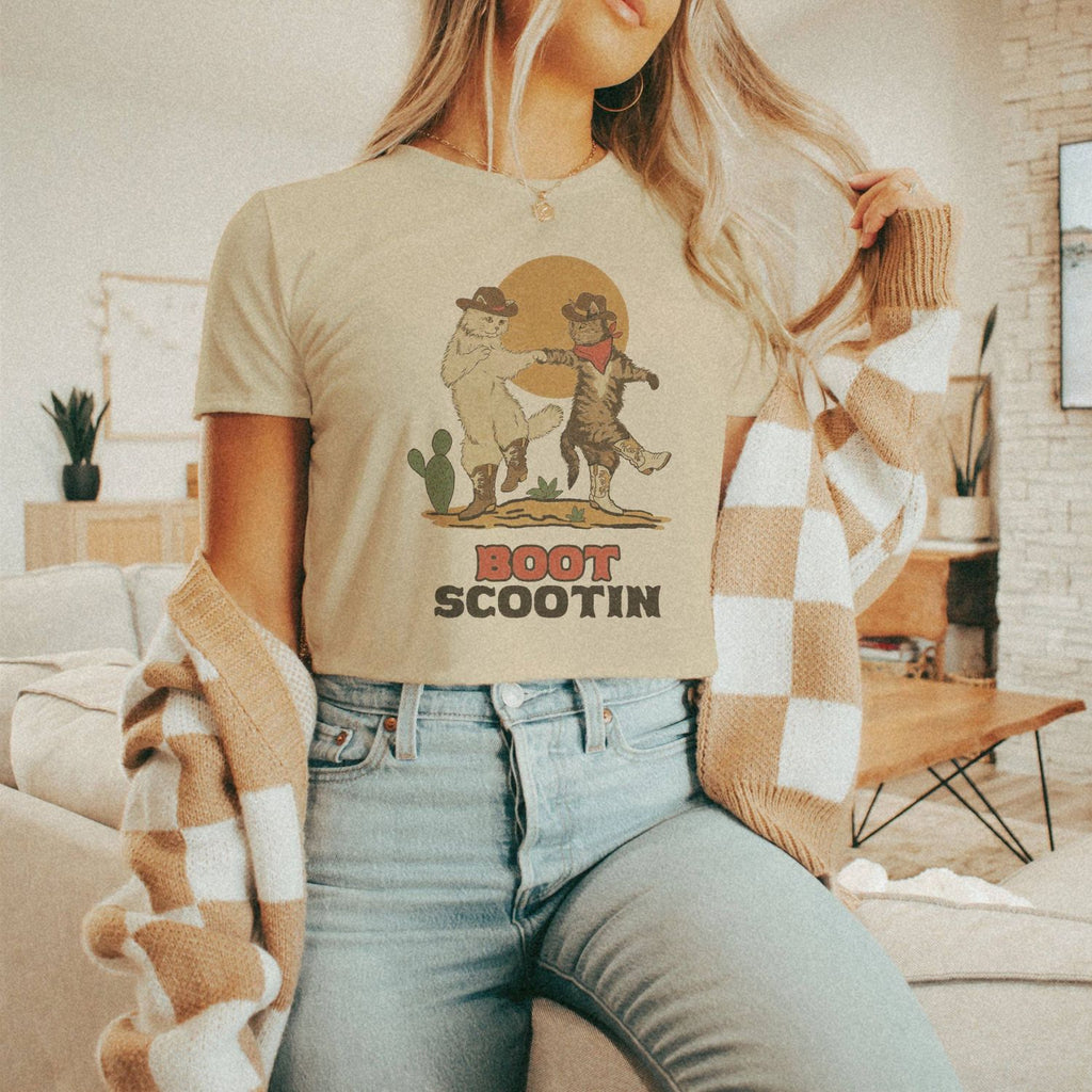 Lifestyle image featuring a model wearing the Cowgirl Boot Scootin Kitties Crop Top.