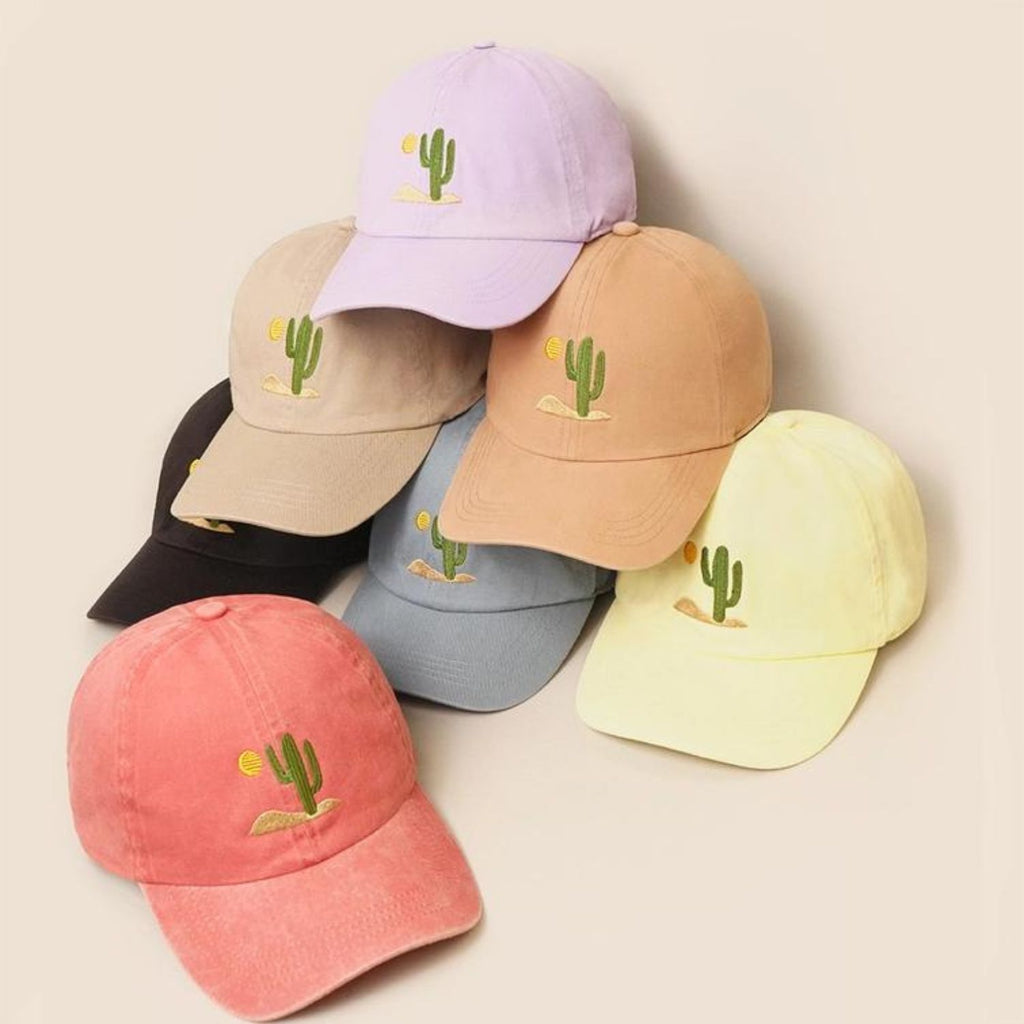 A collection of Cactus Embroidered Cotton Baseball Dad Caps in seven different colors, featuring a cactus and sun design on the front.