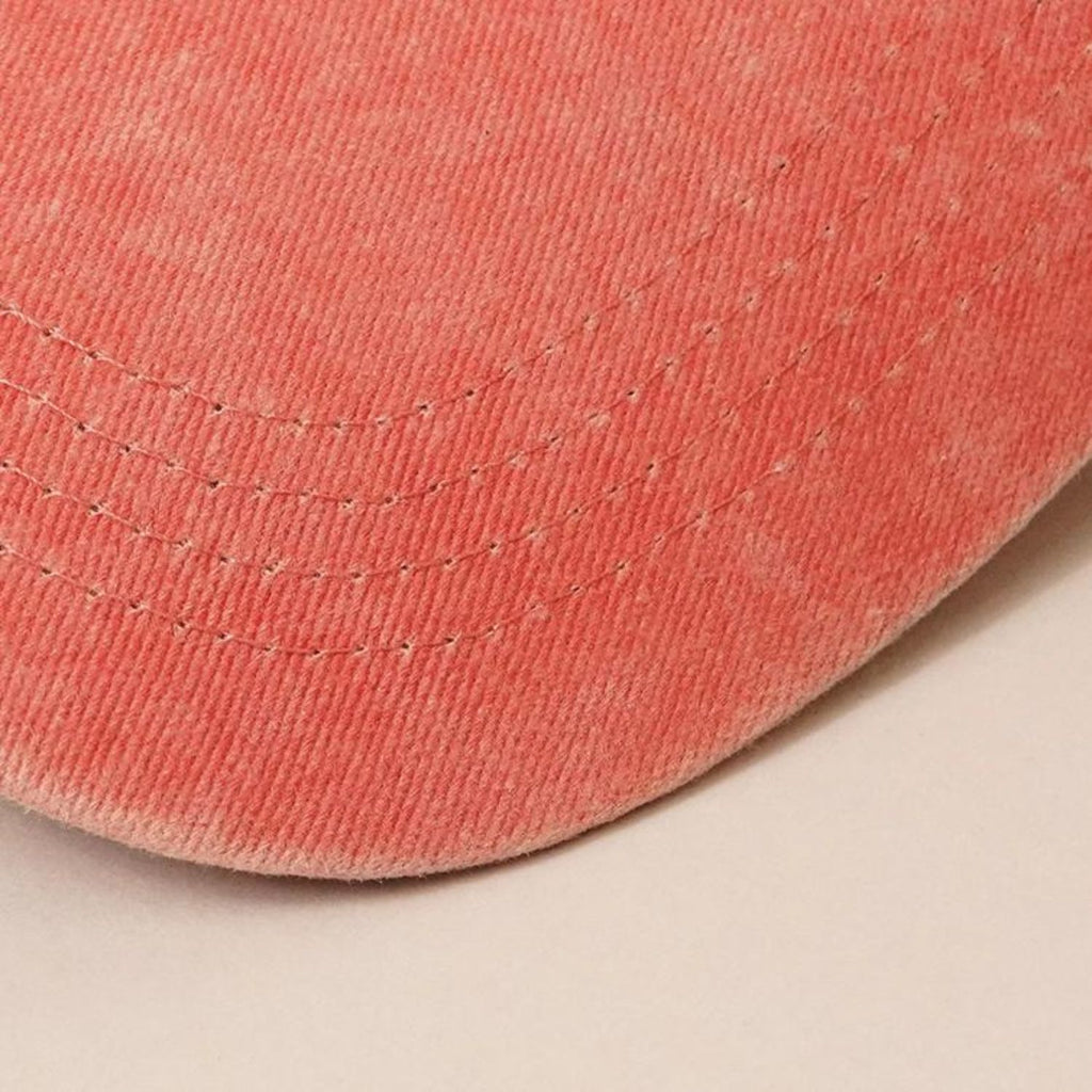 Close-up of the curved brim of the Cactus Embroidered Cotton Baseball Dad Cap in faded red, highlighting the stitching details.