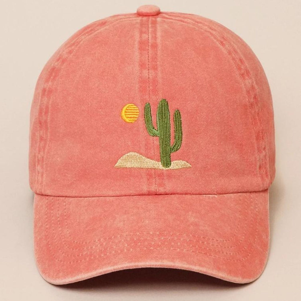 A pink Cactus Embroidered Cotton Baseball Dad Cap featuring a cactus and sun design on the front, with a relaxed fit and pre-curved visor.