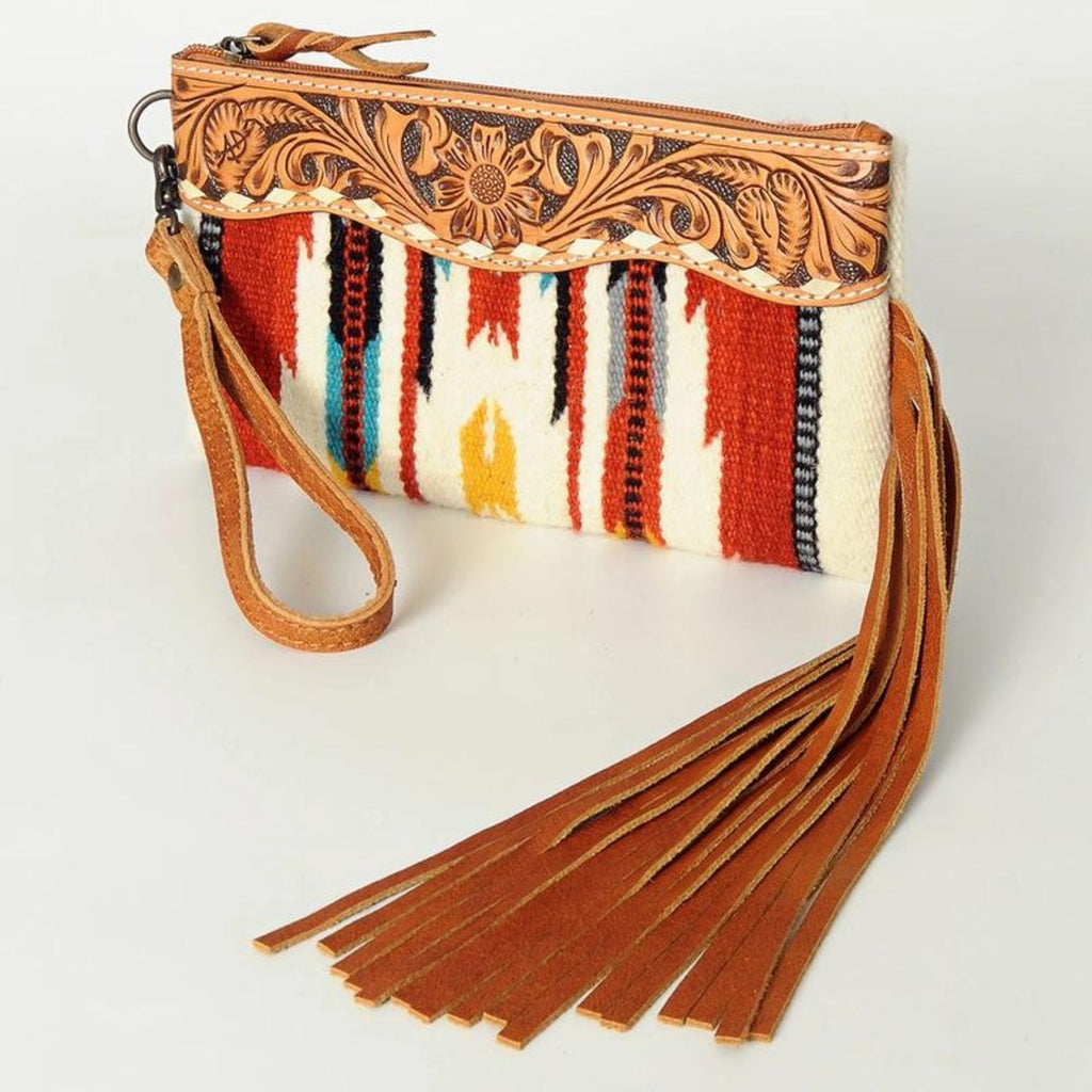 Canyon Breeze Fringe Wristlet featuring hand-tooled leather detailing, colorful woven pattern, and long leather fringe.