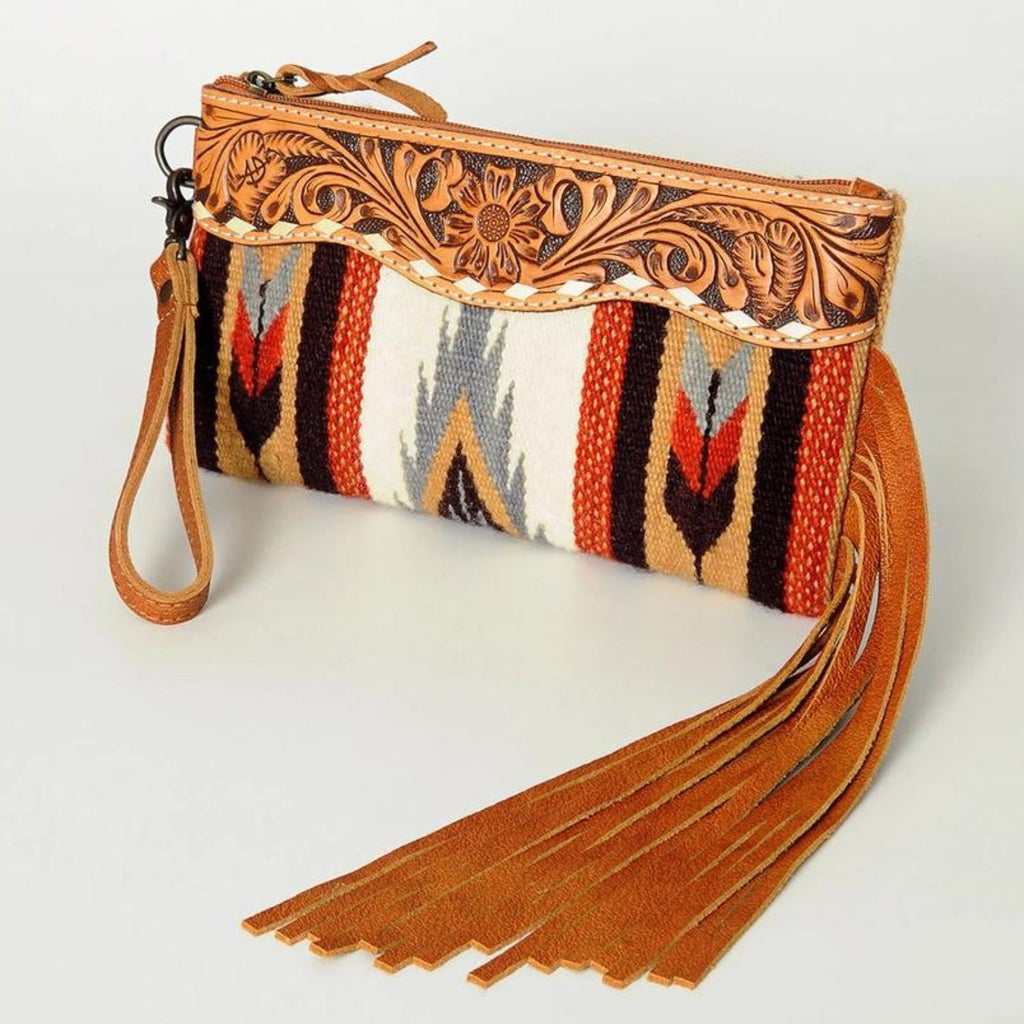 Desert Bloom Handcrafted Wristlet with leather fringe, hand-tooled detailing, and vibrant woven design.