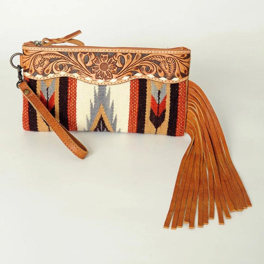 Front view of the Desert Bloom Handcrafted Wristlet featuring leather fringe and intricate hand-tooled detailing.