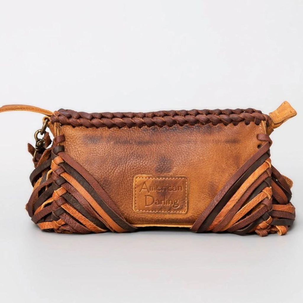 The back of a western-style leather clutch with braided details and a stitched "American Darling" brand patch.