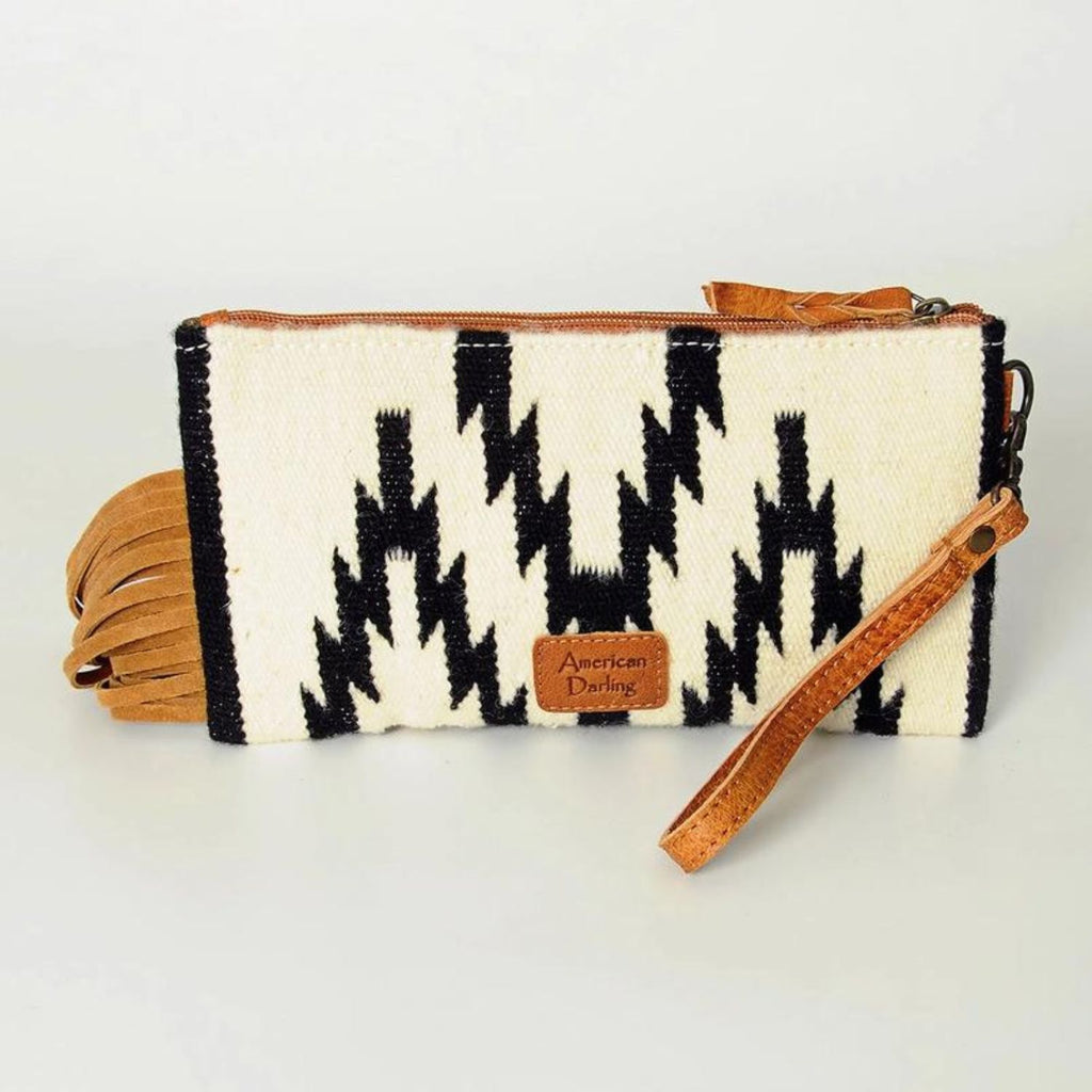 Back view of the Frontier Fringe Leather Wristlet showing black and white woven design and leather wrist strap.