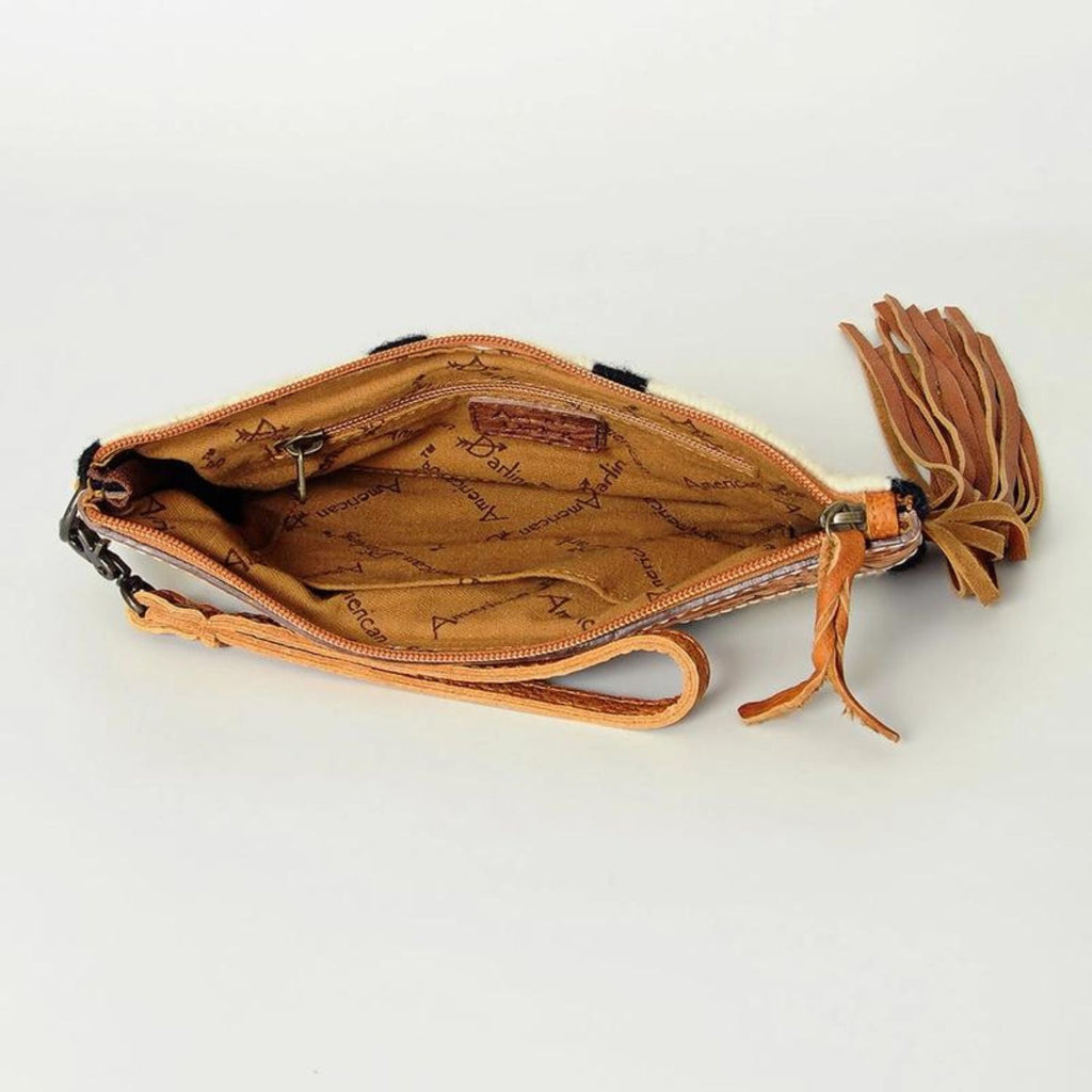 Interior view of the Frontier Fringe Leather Wristlet showing fabric lining and zipper closure.