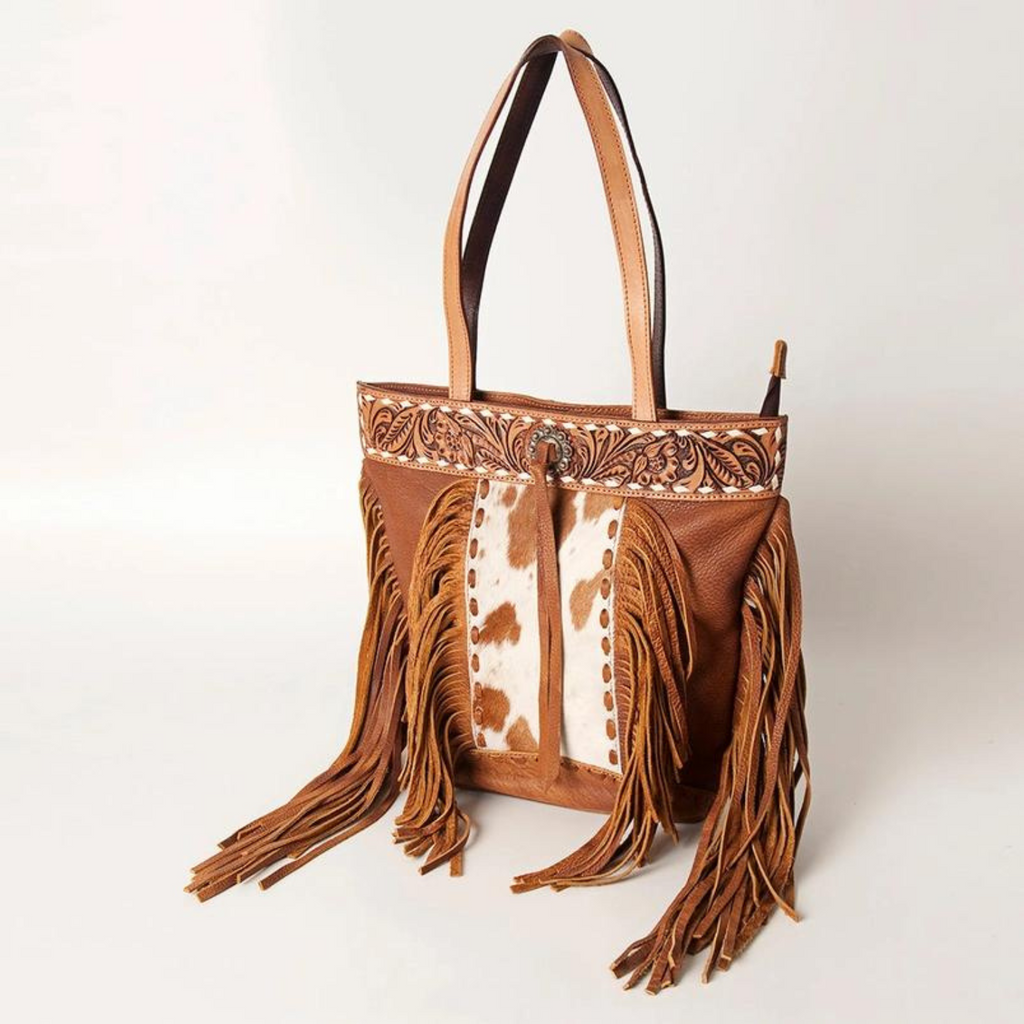 Hand-tooled leather tote with hair-on cowhide and fringes by American Darling