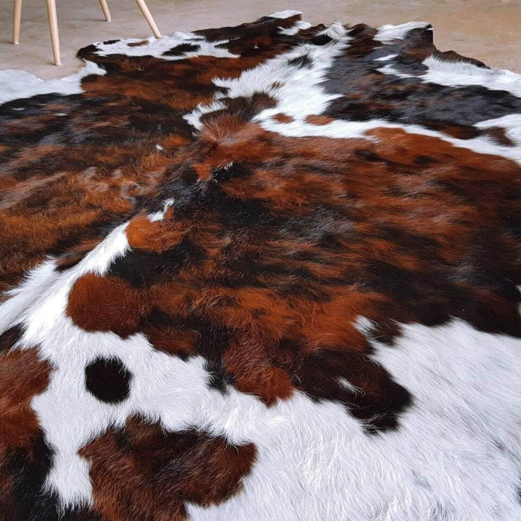 Cowhide rug showcased in a contemporary living space.