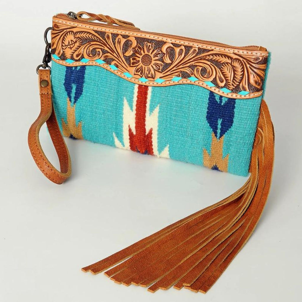 High Plains Heritage Wristlet with hand-tooled leather detailing, turquoise woven pattern, and leather fringe.