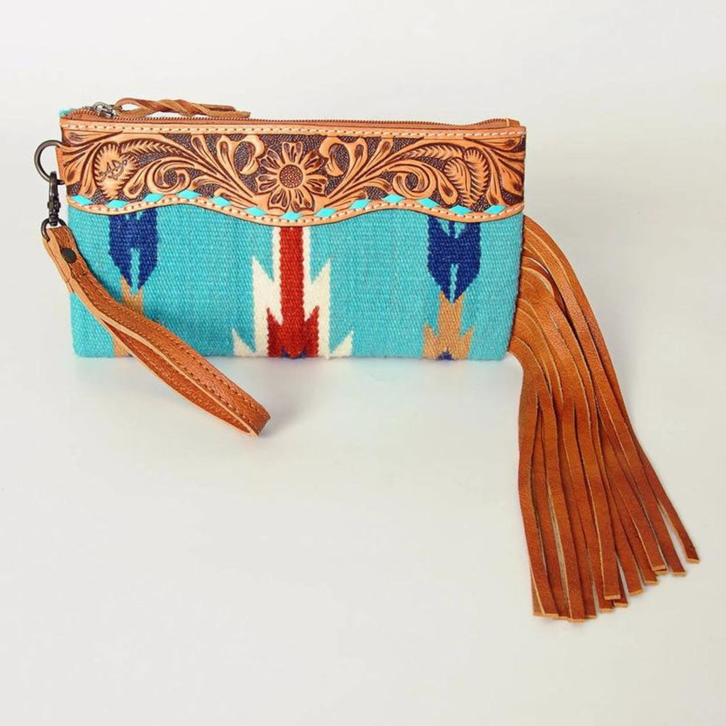 Front view of the High Plains Heritage Wristlet featuring hand-tooled leather and turquoise woven design with leather fringe.