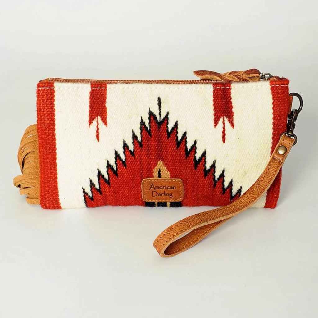 Back view of the Prairie Rose Leather Wristlet featuring a bold red and white southwestern woven fabric design with an American Darling leather logo patch and a detachable leather wrist strap.