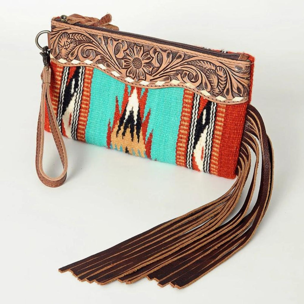 Rodeo Spirit Wool & Leather Wristlet with hand-tooled leather detailing, vibrant turquoise woven pattern, and long leather fringe.