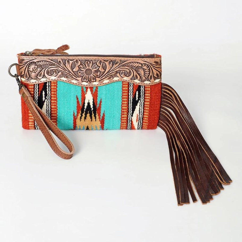 Front view of the Rodeo Spirit Wool & Leather Wristlet featuring hand-tooled leather, turquoise woven pattern, and long leather fringe.