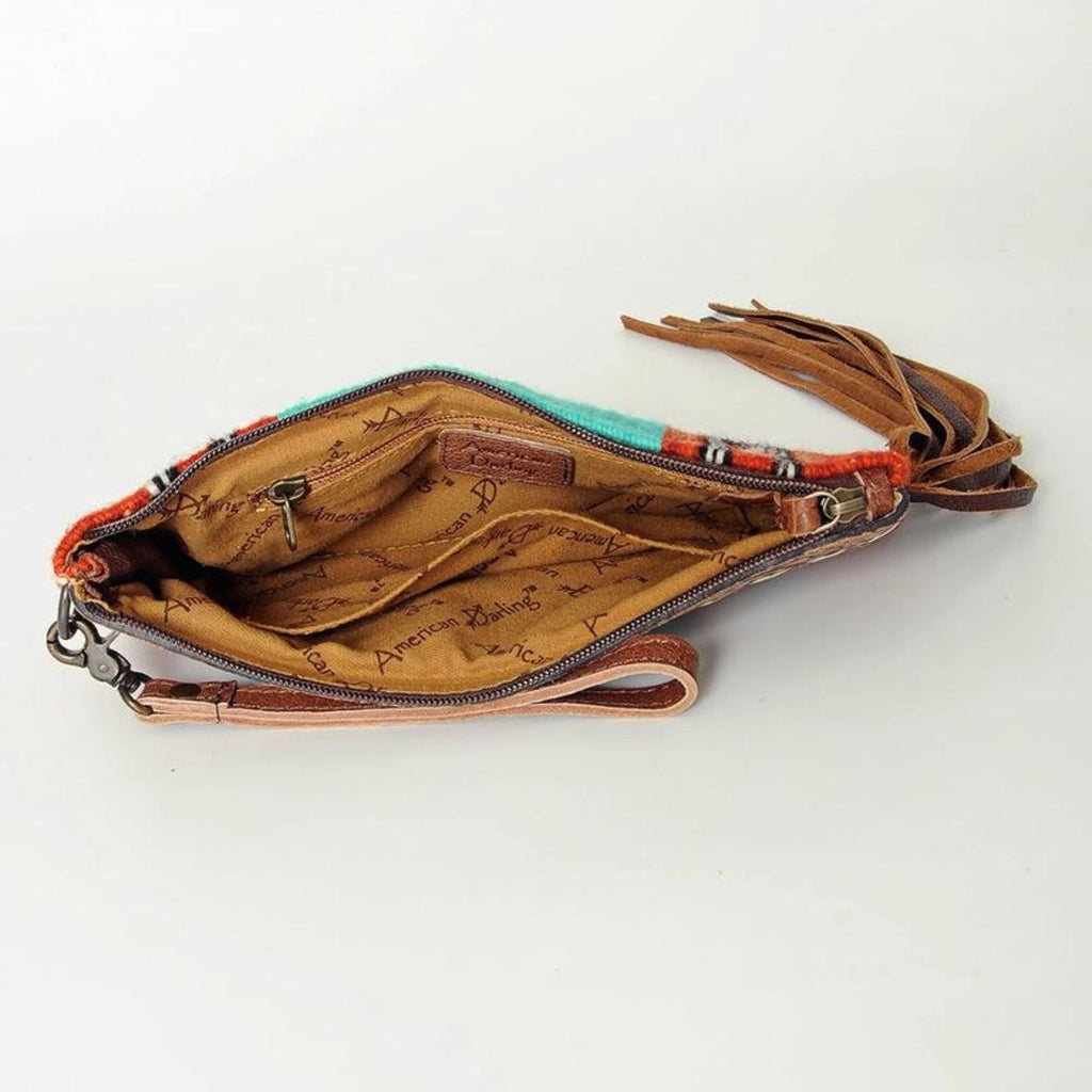 Interior view of the Rodeo Spirit Wool & Leather Wristlet showing fabric lining and zipper closure.