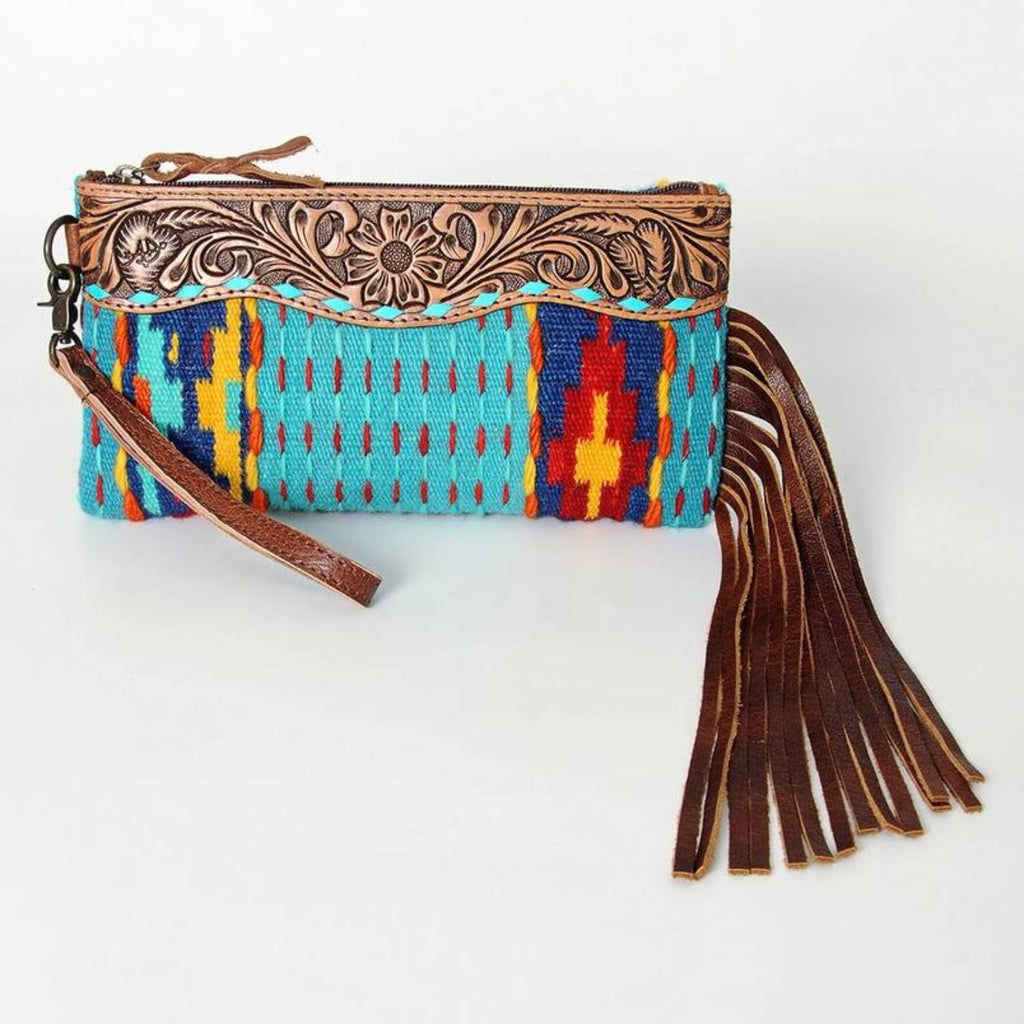 Front view of Sierra Sky Leather Fringe Bag featuring handwoven turquoise, red, and yellow southwestern design, leather floral trim, and long brown leather fringe.