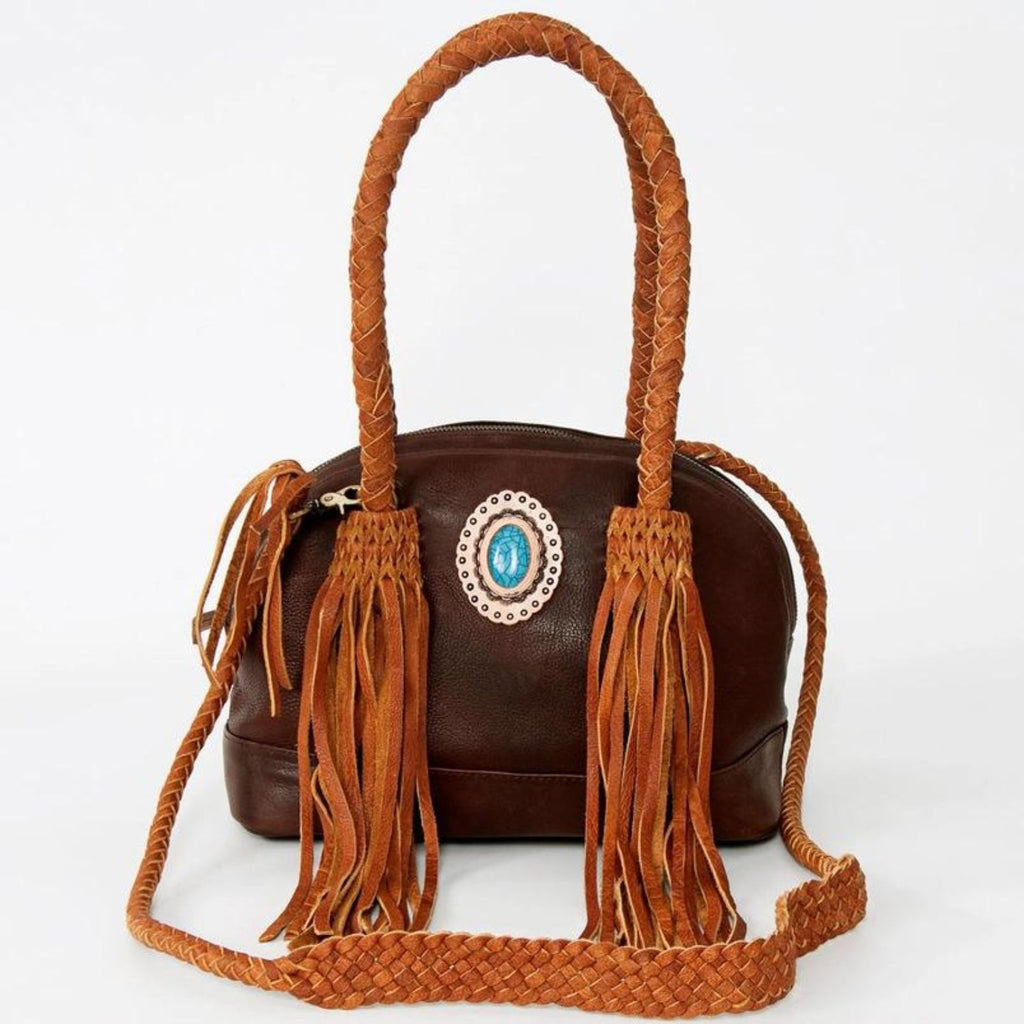 Turquoise Trail Fringed Leather Tote featuring braided handles, leather fringe, and a turquoise stone centerpiece, crafted from genuine full-grain leather for a classic Western look.