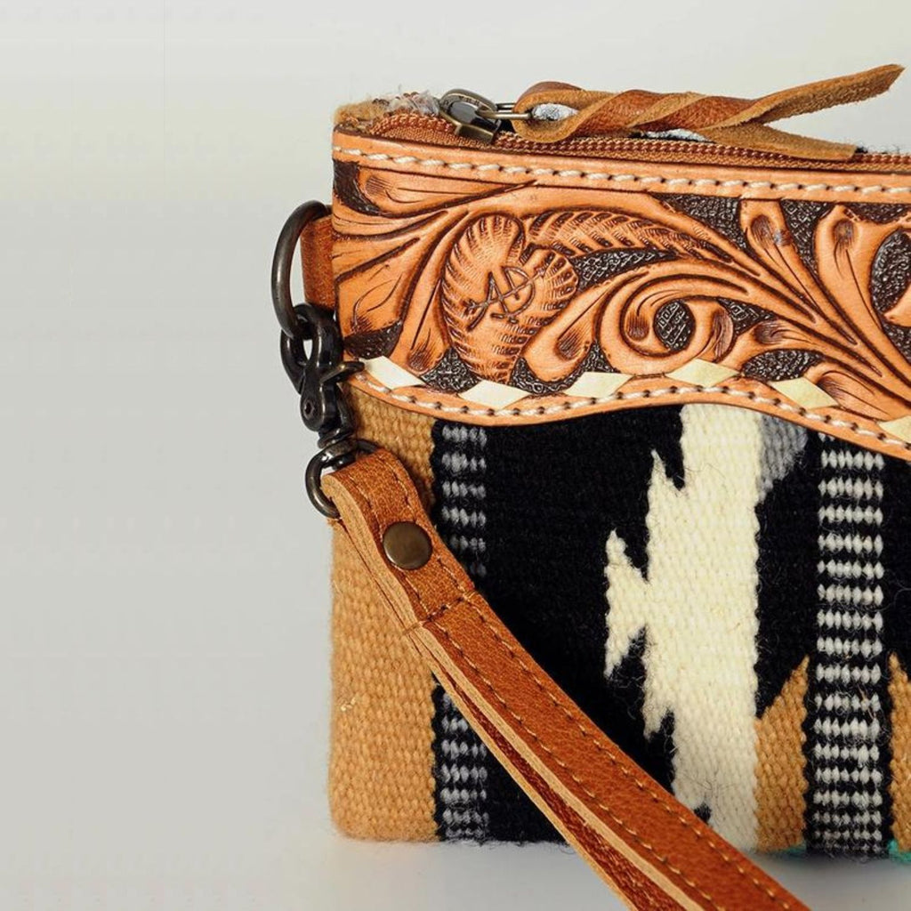 Close-up detail of the Western Trails Leather Fringe Wristlet showcasing hand-tooled leather and antique metal hardware.