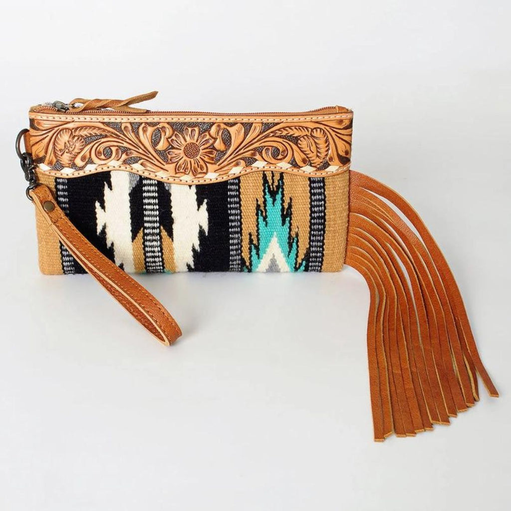 Front view of the Western Trails Leather Fringe Wristlet showcasing hand-tooled floral leather and black and turquoise woven design.